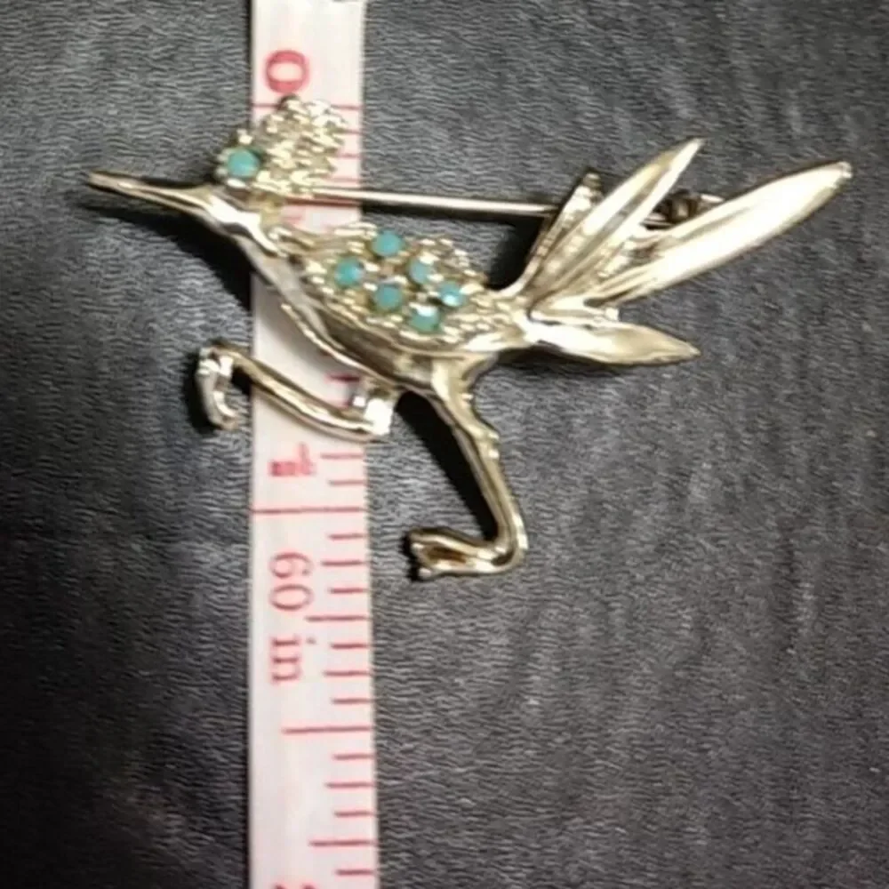 Silver tone vintage roadrunner brooch.